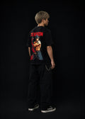 Person wearing a black 'Tekken' t-shirt with graphics on the back against a dark background